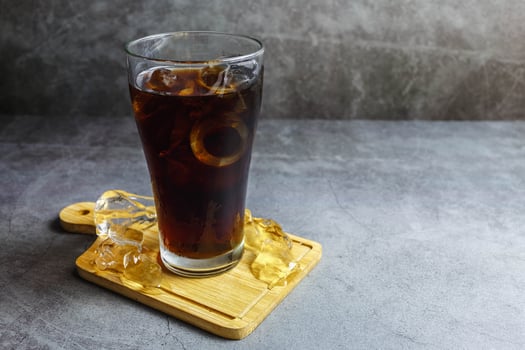 black soft drink in a glass photo