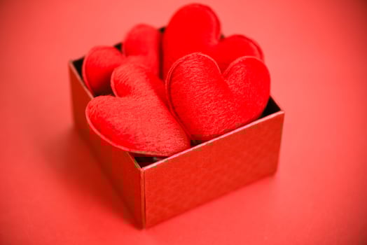 Open gift box with heart in red box surprise for gift to Merry Christmas Holiday Happy new year or romantic Valentines day on red background philanthropy donate help give love take care photo