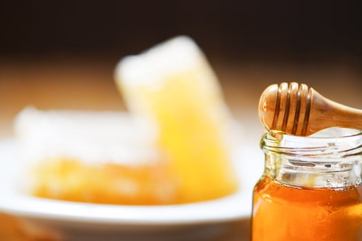Fresh honey sweet in jar glass with wooden dipper - Honeycomb , Honey Bee background photo