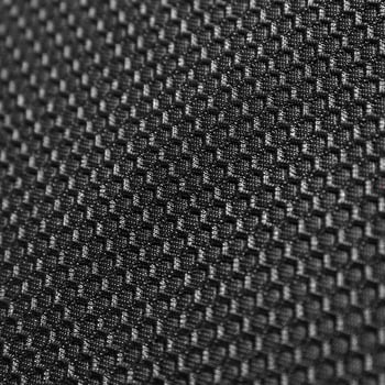 Texture of black leather background with honeycomb shape pattern, macro photo