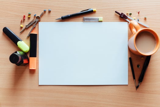 white empty sheet with lots of stationery objects makes photo