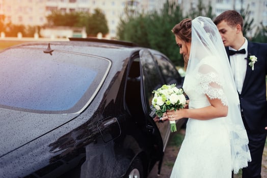 Happy bride and groom near car. photo