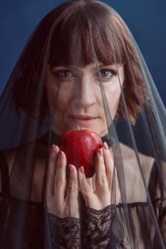 Beautiful woman witch with poison red apple photo