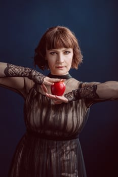 Beautiful woman witch with poison red apple photo