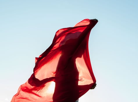 woman wrapped in a red scarf in the wind photo