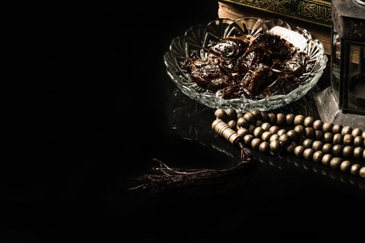 prayer beads with date palm on black background photo