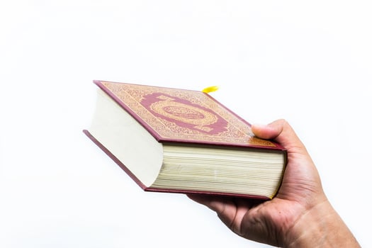 Koran in hand  holy book of Muslims  public item of all muslims photo