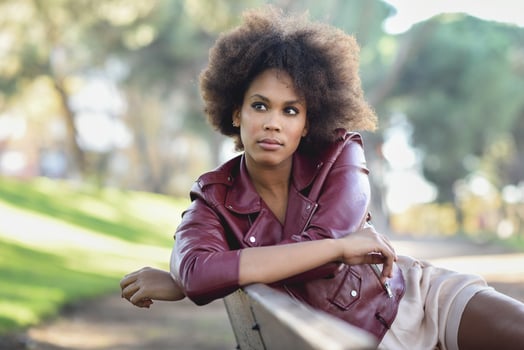 Young black woman with afro hairstyle standing in urban background photo