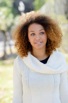 Young African American girl with afro hairstyle and green eyes photo