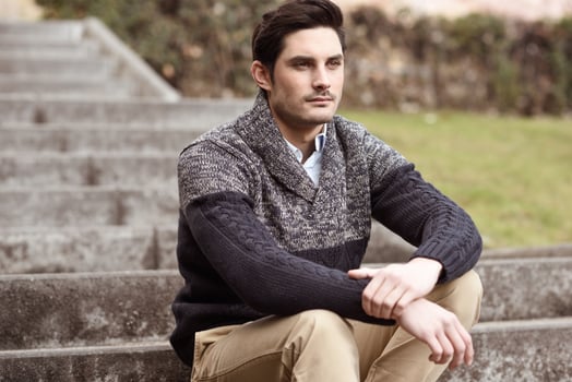 Attractive young handsome man, model of fashion in urban background photo