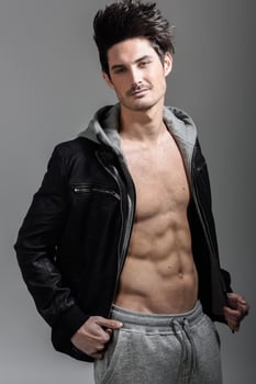 Athletic man wearing hoodie jacket. Studio shot photo
