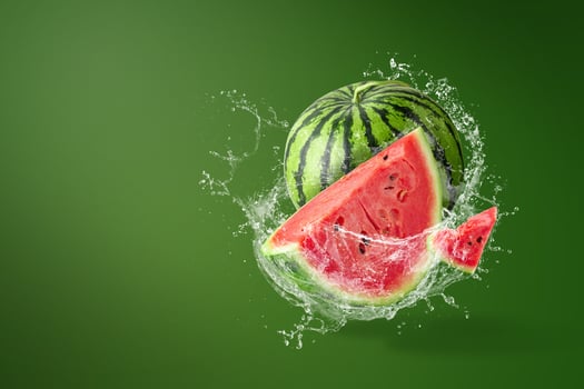 Water splashing on Sliced of watermelon on green background photo