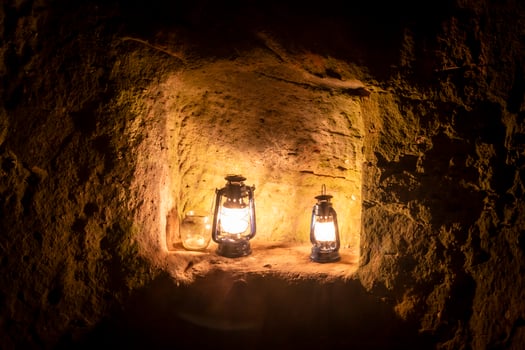 Kerosene lamp is burning at night on a pedestal in an old castle ruin photo
