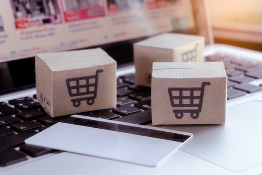 Online shopping. Credit card and cardboard box with a shopping cart logo on laptop keyboard. Shopping service on The online web. offers home delivery photo