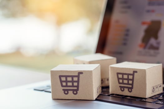Shopping online. Cardboard box with a shopping cart logo on laptop keyboard. Shopping service on The online web. offers home delivery photo