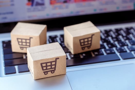 Shopping online. Cardboard box with a shopping cart logo on laptop keyboard. Shopping service on The online web. offers home delivery photo