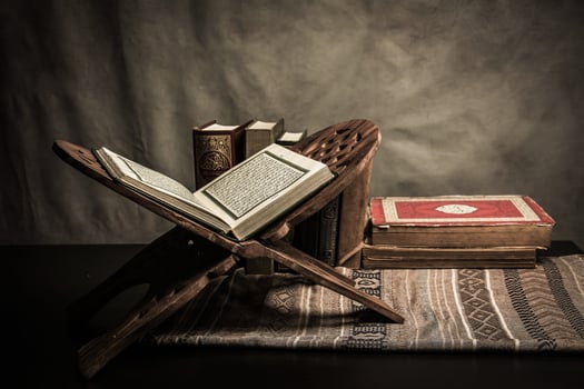 Koran - holy book of Muslims  public item of all muslims  on the table , still life photo