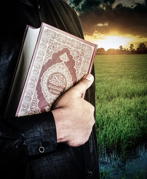 Koran in hand - holy book of Muslims  public item of all muslims photo