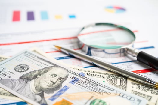Magnifying glass on charts graphs paper. Financial development, Banking Account, Statistics, Investment Analytic research data economy, Stock exchange trading, Business office company meeting concept. photo