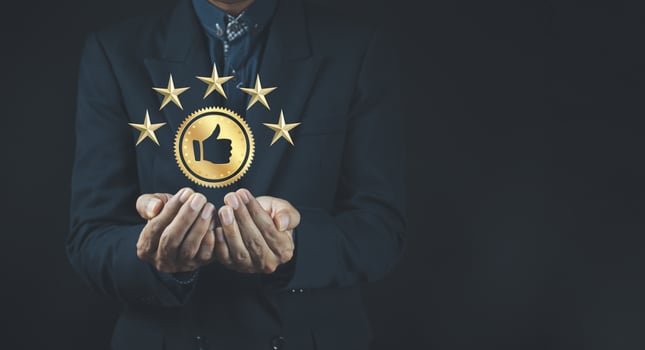 Quality product symbol in the hand of a business man.Hand shows the sign of the top service Quality assurance. photo