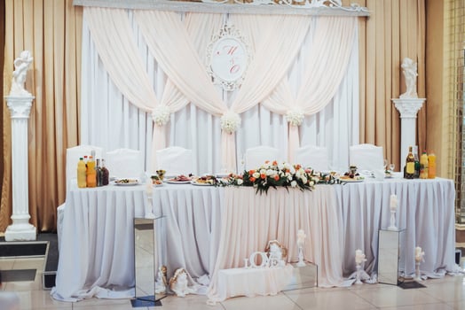 luxury decorated main table in the wedding hall photo