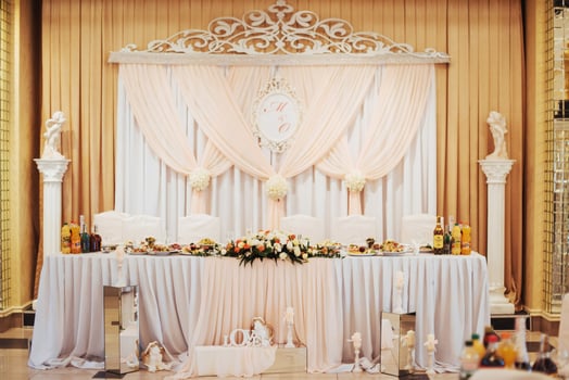 luxury decorated main table in the wedding hall photo