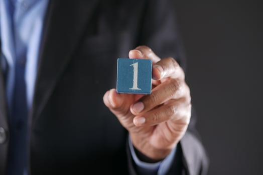 men holding number one close up photo