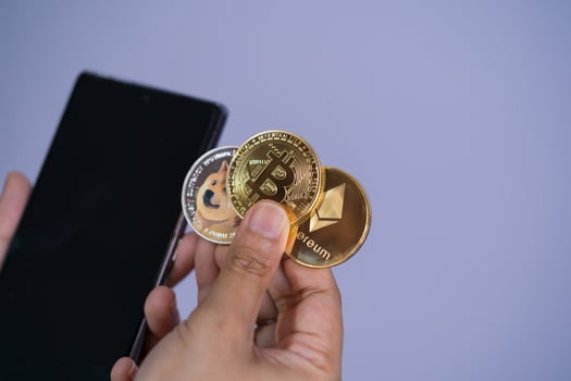 Golden bitcoin coin Dogecoin DOGE, Ethereum ETH group included with Cryptocurrency on hand woman or girl and mobile phone smartphone Filed put and give purple background. shopping online concept. photo