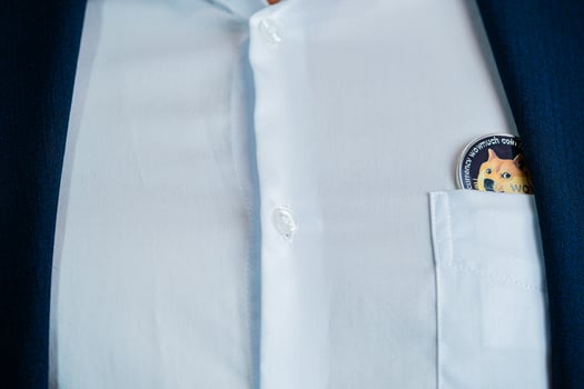 Dogecoin DOGE included with Cryptocurrency on suit bag business man wearing a blue suit. Filed and put and give to me. photo