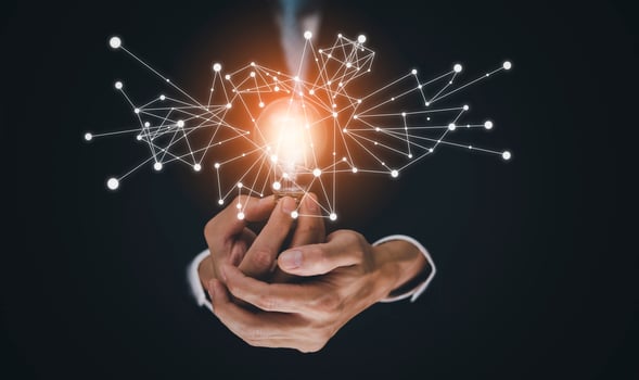 The Man hand holding light bulb with line connect and working on the desk, Creativity and innovation are keys to success.Concept of new idea and innovation with energy and power , working at home, photo