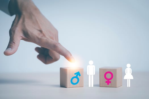 concept equality and differences between men and women, Hand touch wooden cube with male icon on top of cubes, gender discrimination in employment. Wooden blocks with male and female symbols. photo