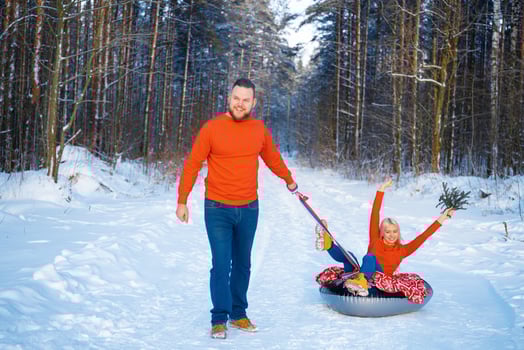 happy guy and girl riding in the snow photo