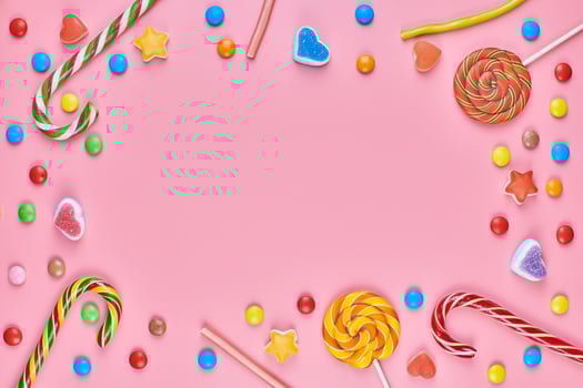 Sweet candy copy space frame with lollipops on pink background photo