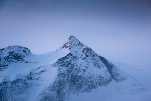 Blue snow peak in blizzard at the morning photo