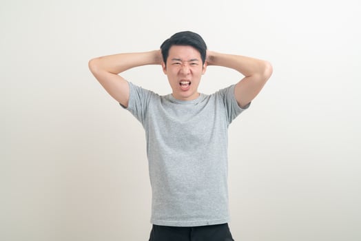 young Asian man with stress face or working hard photo