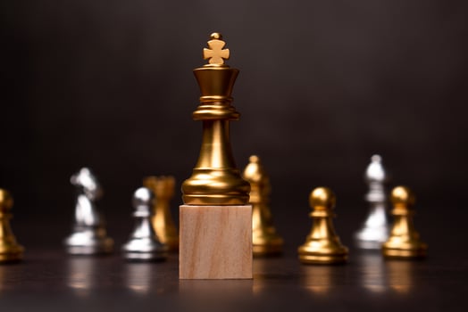 Golden king chess standing on a wooden stand. The concept of Leaders in good organizations must have a vision and can predict business trends and assess competitors photo