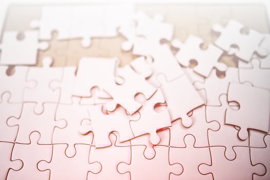 A white jigsaw puzzle is placed on it. photo