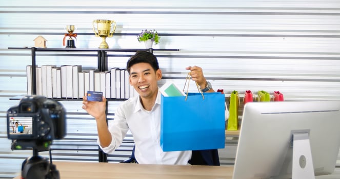 Asian man  blogger broadcasting a video for selling product online .Shopping online concept photo