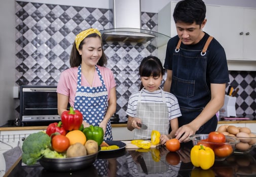 Asian families are cooking and parents are teaching their daughters to cook in the kitchen at home. Family activities on holidays and Happy in recreation concept photo