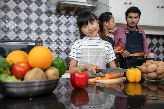 Happy Family have Dad, Mom and their little daughter Cooking Together in the Kitchen photo