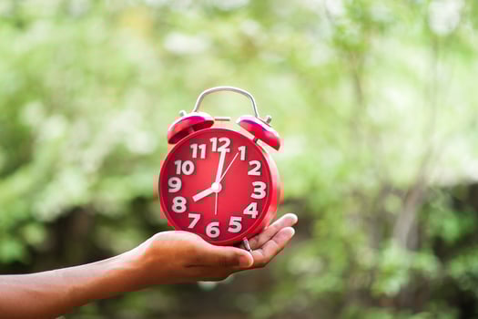 Hands and red clocks photo