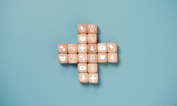 Wooden block cube which print screen health care and medical icons for healthy and wellness concept. photo