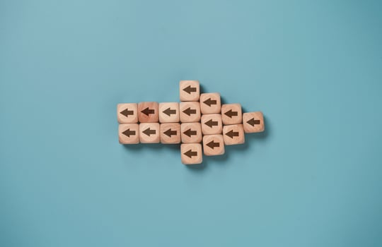 Disruption and technology transformation concept , Wooden bock cube arrange in big arrow which small arrow inside and different direction. photo