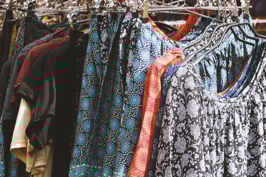 clothes rack with boho hippie style women's fashion photo