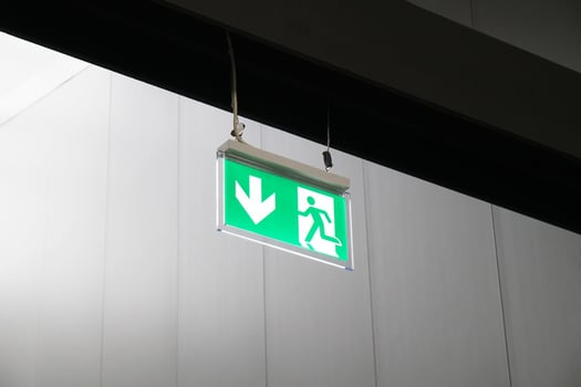 emergency exit or fire escape sign with running man symbol and arrow photo