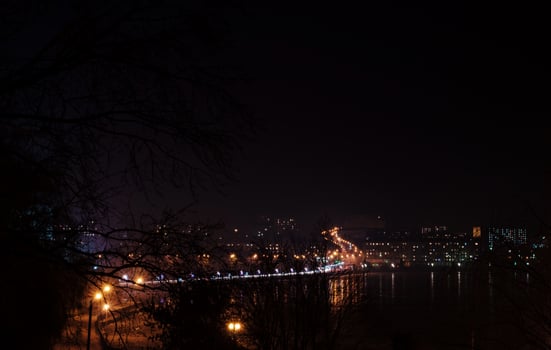 Panorama of night city lights and reflections on lake at Ternopil, Ukraine, Europe. photo