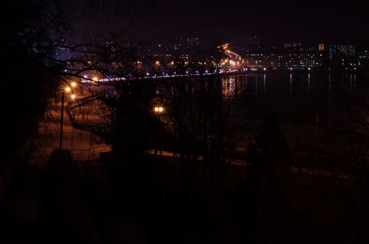 Panorama of night city lights and reflections on lake at Ternopil, Ukraine, Europe. photo