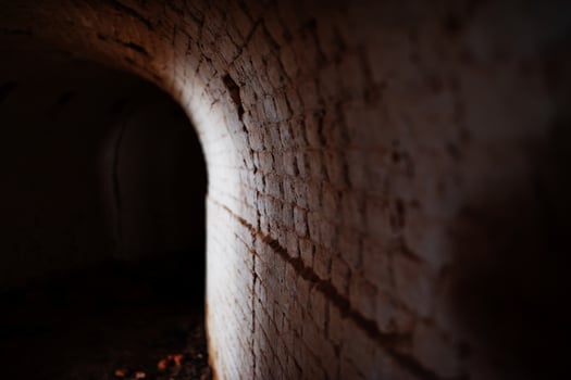 Scary brick arch tunnel on dark and some light. photo