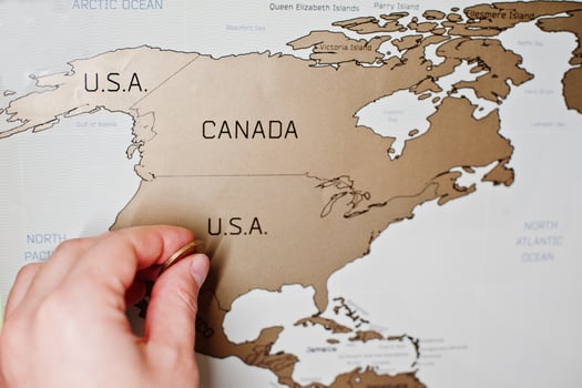 Scratch travel map of the world. Hand of man erase USA with coin. photo