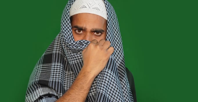 Indian muslim man anger hiding his face on Green screen background. photo